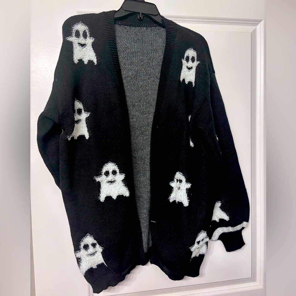 Oversized cardigan.  Black with white ghosts on front.  Soft, hits mid thigh.  M